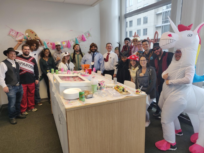 a large team dressed in Halloween costumes