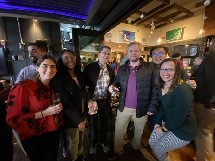 a group of team members posing for a photo during a company holiday pary
