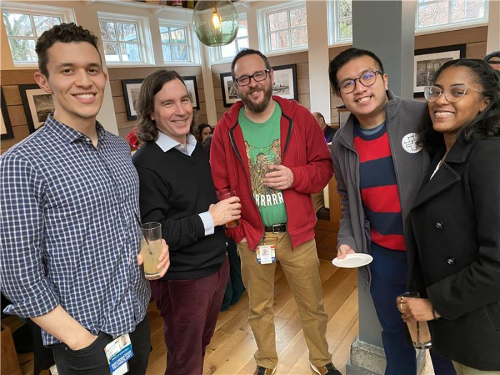 a group of team members posing for a photo during a company holiday pary